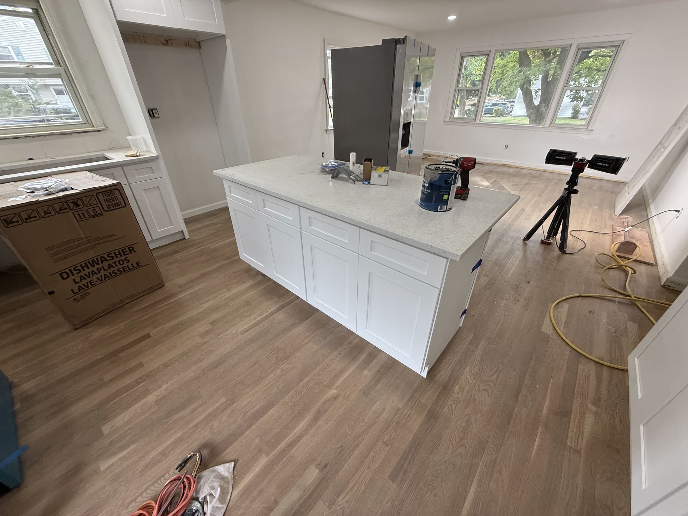 Kitchen island detail with fresh oak floors, finished by Rise Builders